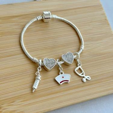 Imagem de Pulseira profissão enfermeira com 5 berloques: seringa, estetoscópio, separador coração cravejado e chapéu de enfermeira - banhado a prata