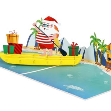 Imagem de iGifts And Cards Cartão de Natal pop-up 3D Papai Noel tropical - Desejos quentes de baixo para baixo! Saudação engraçada de férias na praia com Papai Noel remando uma canoa cheia de presentes – 15 cm