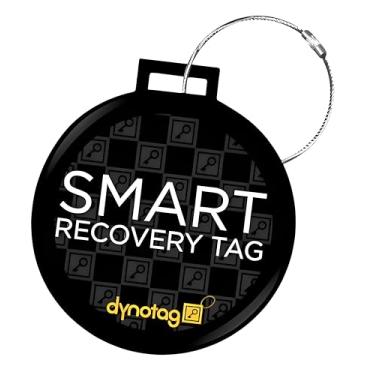 Imagem de Dynotag Web Enabled Smart Dlx. Etiqueta de identificação de bagagem de aço + laço de aço com DynoIQ e serviço de recuperação vitalícia, Preto/branco, The tag itself is a disc 2.56 inches in diameter.