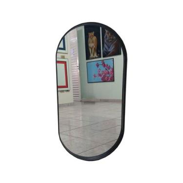 Imagem de Espelho oval com moldura em couro