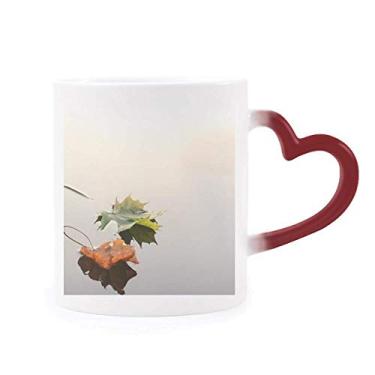Imagem de Caneca sensível ao calor com folhas caídas de planta, água natural, caneca vermelha que muda de cor