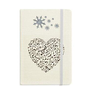 Imagem de Caderno de notas musicais em formato de coração, textura de papel, flocos de neve, inverno