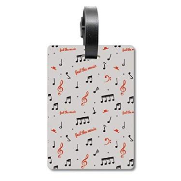 Imagem de Bolsa de mala vermelha e preta com notas musicais e etiqueta para cartão de bagagem