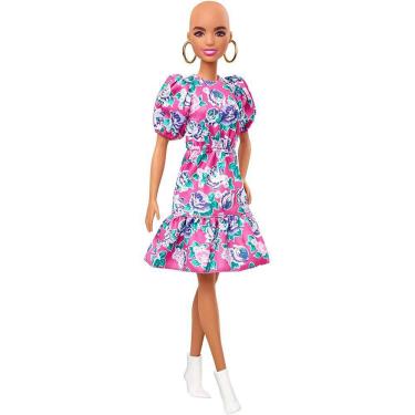 Imagem de Boneca Barbie Fashionistas #150 com look sem cabelo vestindo vestido floral rosa, botas brancas e brincos, brinquedo para crianças de 3 a 8 anos
