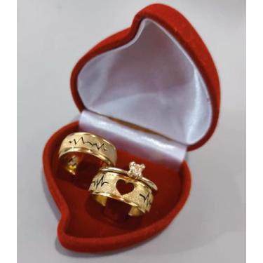 Imagem de Alianças em aço inox banhadas a ouro ( leve de brinde um anel solitári