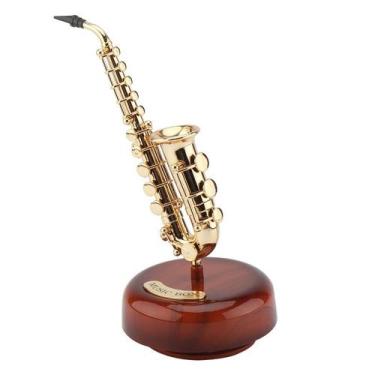 Imagem de Instrumento dourado com design de saxofone giratório com design de cai