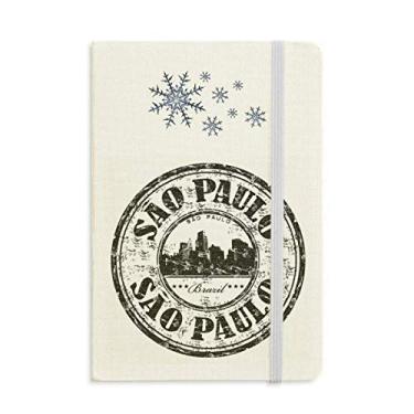 Imagem de Caderno com elementos culturais do Brasil, pau de pintura, flocos de neve, inverno