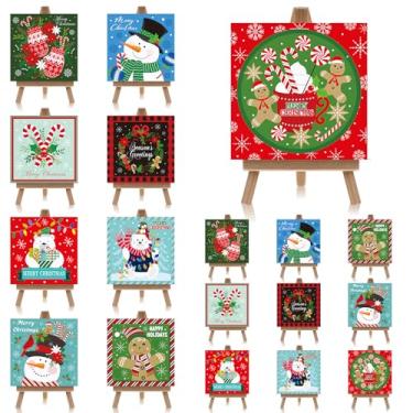 Imagem de Wovnet Conjunto de 18 mini arte em tela de Natal 10 cm x 10 cm com cavaletes de exibição de madeira a granel pequenas impressões de parede de Natal para decoração de sala de estar escritório pinturas